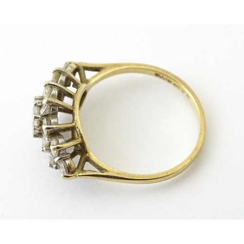 712 - A 9ct gold ring set with cluster of white stones. Ring size approx. J 1/2