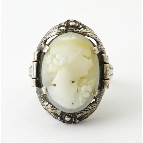 715 - A Continental silver ring set with central cameo style detail. Ring size approx. O