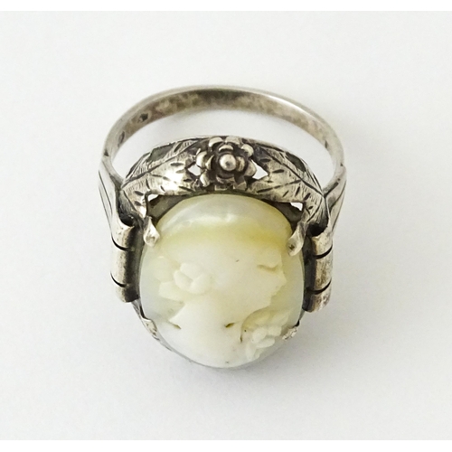 715 - A Continental silver ring set with central cameo style detail. Ring size approx. O