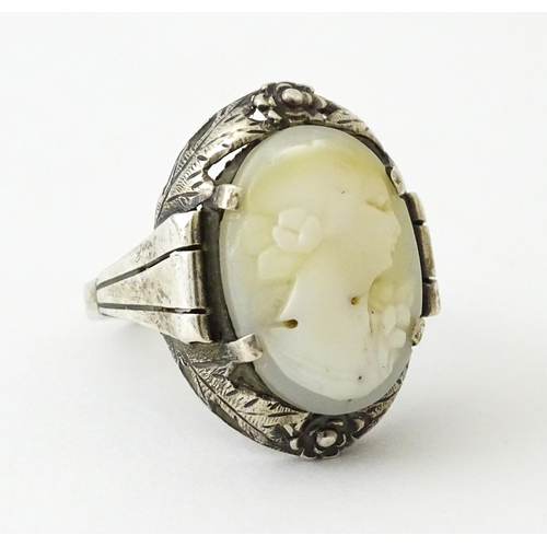 715 - A Continental silver ring set with central cameo style detail. Ring size approx. O