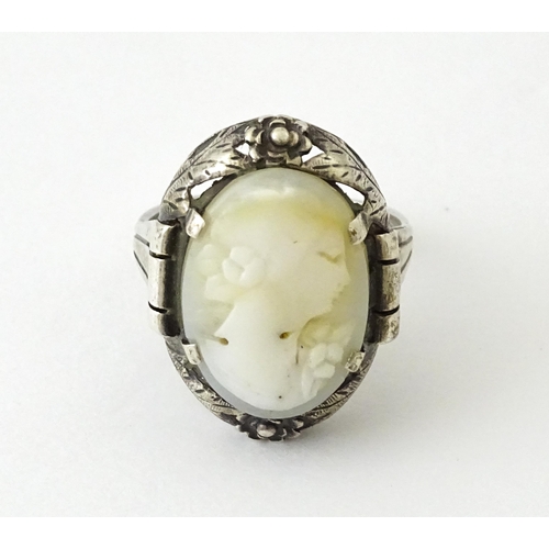 715 - A Continental silver ring set with central cameo style detail. Ring size approx. O