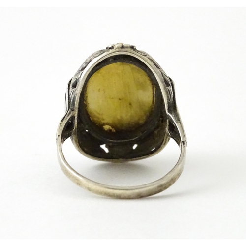 715 - A Continental silver ring set with central cameo style detail. Ring size approx. O