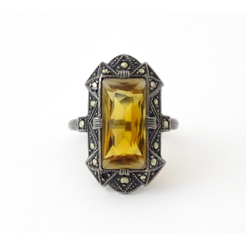 717 - A Continental silver ring set with central citrine bordered by marcasite. Ring size approx. I