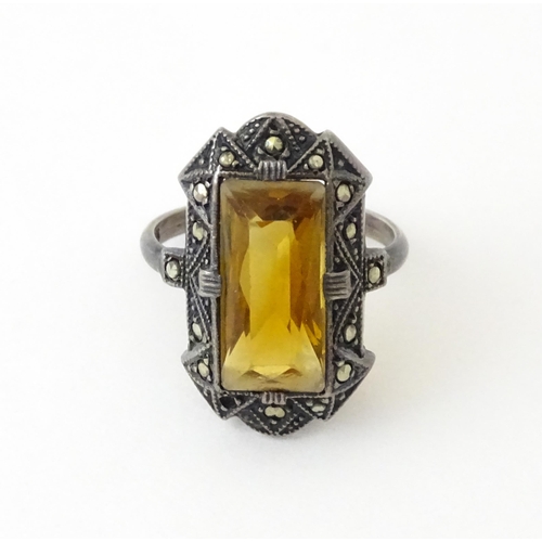 717 - A Continental silver ring set with central citrine bordered by marcasite. Ring size approx. I