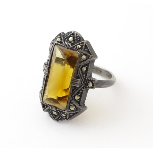 717 - A Continental silver ring set with central citrine bordered by marcasite. Ring size approx. I