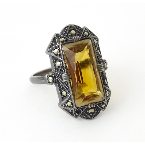 717 - A Continental silver ring set with central citrine bordered by marcasite. Ring size approx. I