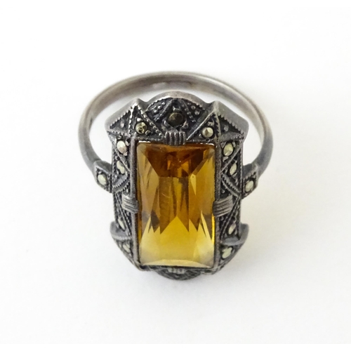 717 - A Continental silver ring set with central citrine bordered by marcasite. Ring size approx. I