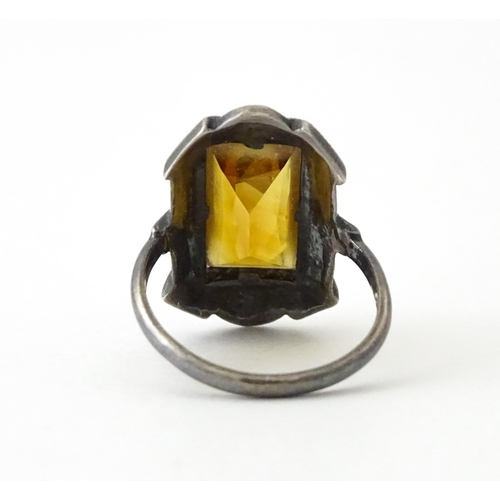 717 - A Continental silver ring set with central citrine bordered by marcasite. Ring size approx. I