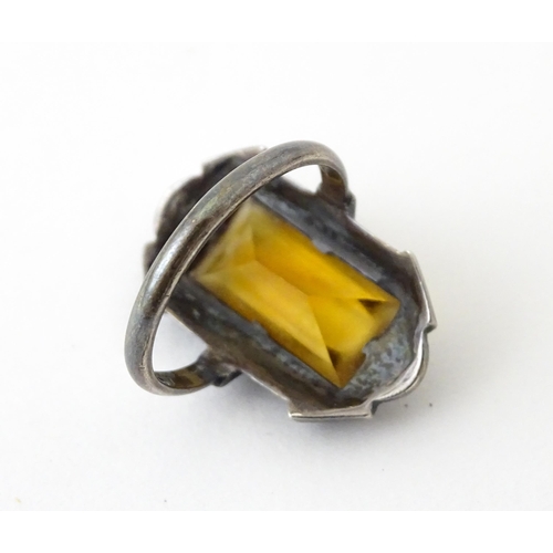 717 - A Continental silver ring set with central citrine bordered by marcasite. Ring size approx. I