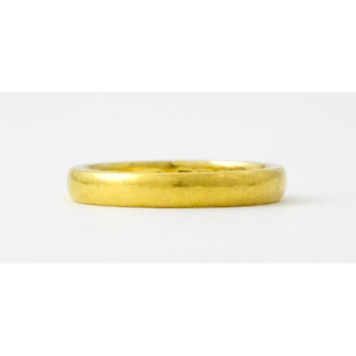 718 - A 22ct gold wedding band Ring size approx. L 1/2