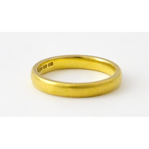 718 - A 22ct gold wedding band Ring size approx. L 1/2