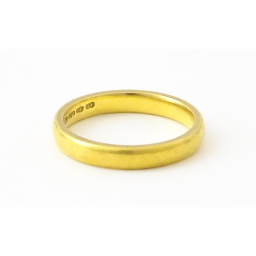 718 - A 22ct gold wedding band Ring size approx. L 1/2