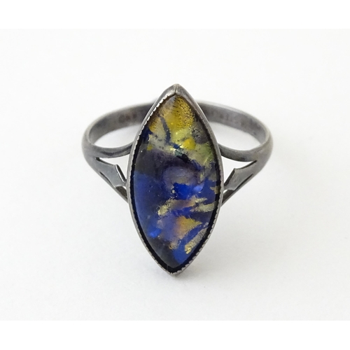 719 - An early 20thC silver ring with butterfly wing detail by Thomas L Mott. Ring size approx. L