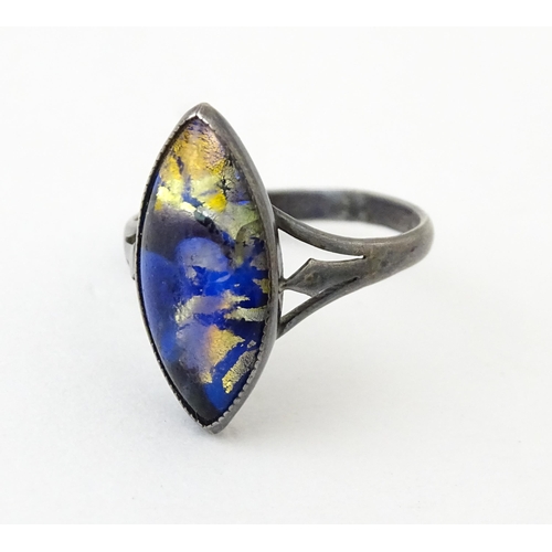 719 - An early 20thC silver ring with butterfly wing detail by Thomas L Mott. Ring size approx. L