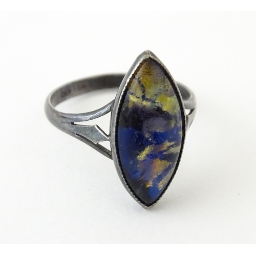 719 - An early 20thC silver ring with butterfly wing detail by Thomas L Mott. Ring size approx. L