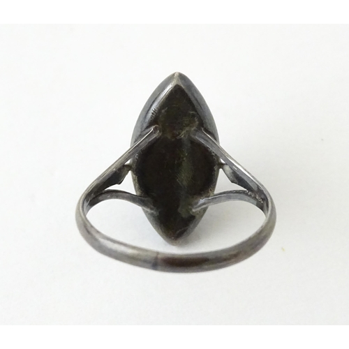 719 - An early 20thC silver ring with butterfly wing detail by Thomas L Mott. Ring size approx. L