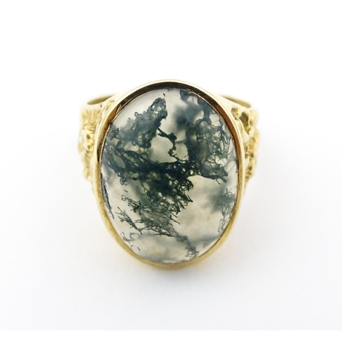 723 - A 9ct gold ring set with moss agate cabochon. Ring size approx. R 1/2