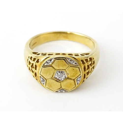 725 - A 9ct gold gentleman's ring with football decoration set with diamonds. Ring size approx. T