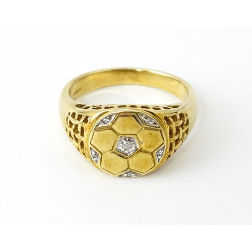 725 - A 9ct gold gentleman's ring with football decoration set with diamonds. Ring size approx. T