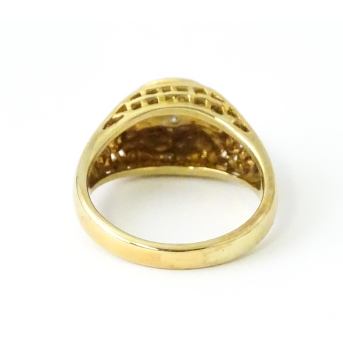 725 - A 9ct gold gentleman's ring with football decoration set with diamonds. Ring size approx. T