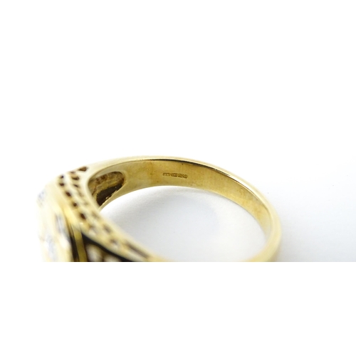 725 - A 9ct gold gentleman's ring with football decoration set with diamonds. Ring size approx. T