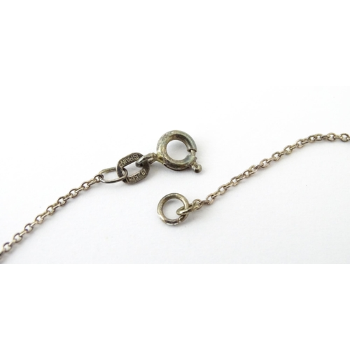 727 - A Charles Horner silver ring. Together with a silver chain and white metal pendant. Ring size approx... 