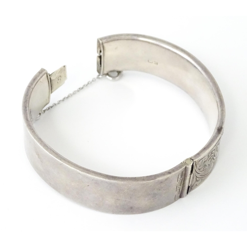 732 - A silver bracelet of bangle form. Hallmarked Chester 1953