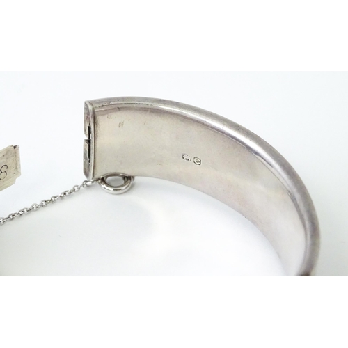 732 - A silver bracelet of bangle form. Hallmarked Chester 1953