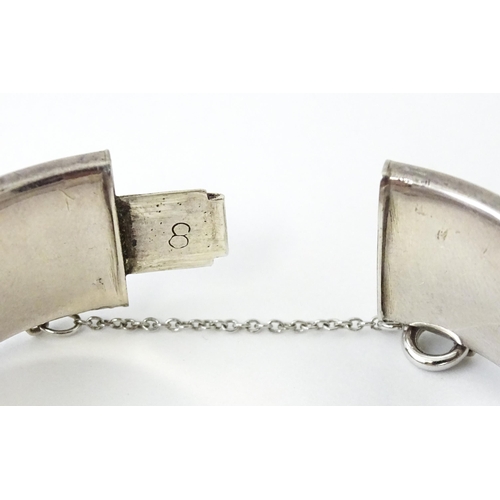 732 - A silver bracelet of bangle form. Hallmarked Chester 1953