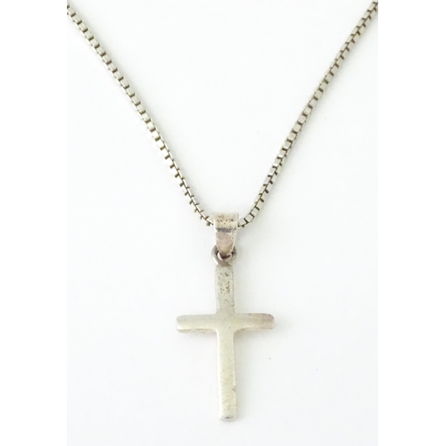 739 - A silver necklace with silver cross formed pendant. Approx 19