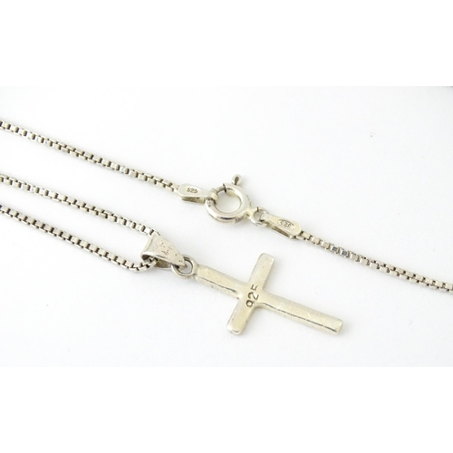 739 - A silver necklace with silver cross formed pendant. Approx 19