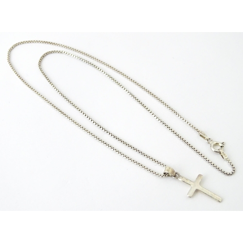 739 - A silver necklace with silver cross formed pendant. Approx 19