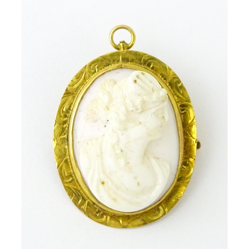 741 - A Cameo brooch with relief decoration of a female bust within a yellow metal surround. 1 1/4