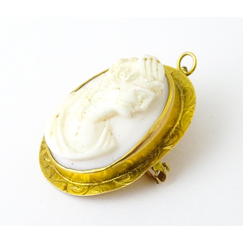 741 - A Cameo brooch with relief decoration of a female bust within a yellow metal surround. 1 1/4