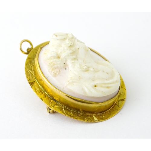 741 - A Cameo brooch with relief decoration of a female bust within a yellow metal surround. 1 1/4