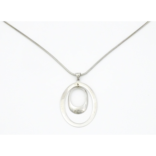 743 - A silver necklace with oval pendant. Approx 19