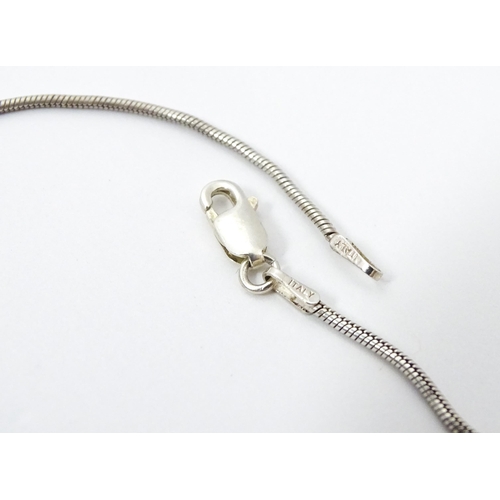 743 - A silver necklace with oval pendant. Approx 19