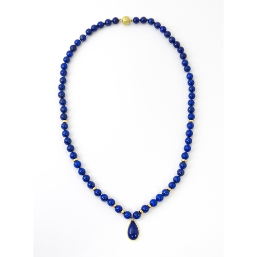 745 - A lapis lazuli bead necklace with drop detail, and silver gilt clasp. Approx. 23