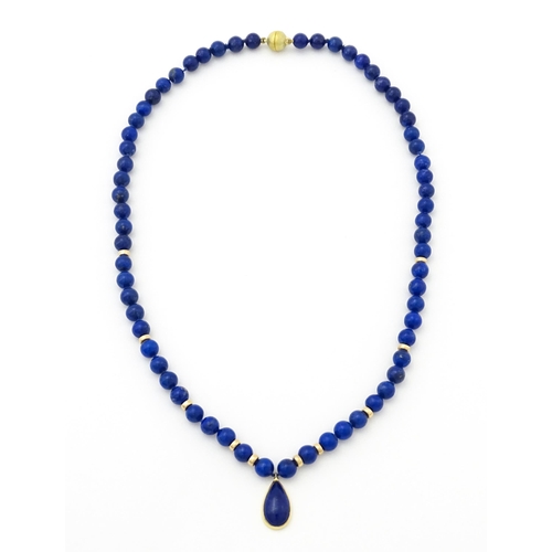 745 - A lapis lazuli bead necklace with drop detail, and silver gilt clasp. Approx. 23