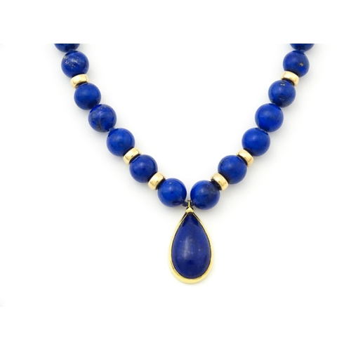 745 - A lapis lazuli bead necklace with drop detail, and silver gilt clasp. Approx. 23