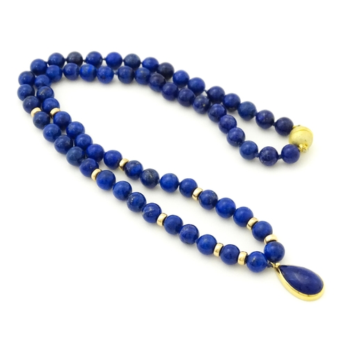 745 - A lapis lazuli bead necklace with drop detail, and silver gilt clasp. Approx. 23