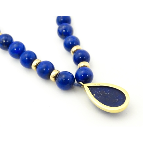 745 - A lapis lazuli bead necklace with drop detail, and silver gilt clasp. Approx. 23