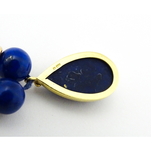 745 - A lapis lazuli bead necklace with drop detail, and silver gilt clasp. Approx. 23