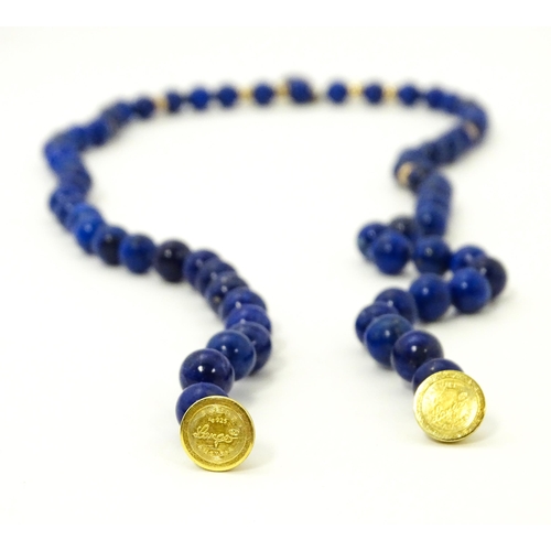 745 - A lapis lazuli bead necklace with drop detail, and silver gilt clasp. Approx. 23