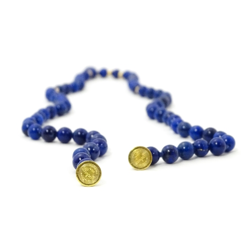 745 - A lapis lazuli bead necklace with drop detail, and silver gilt clasp. Approx. 23