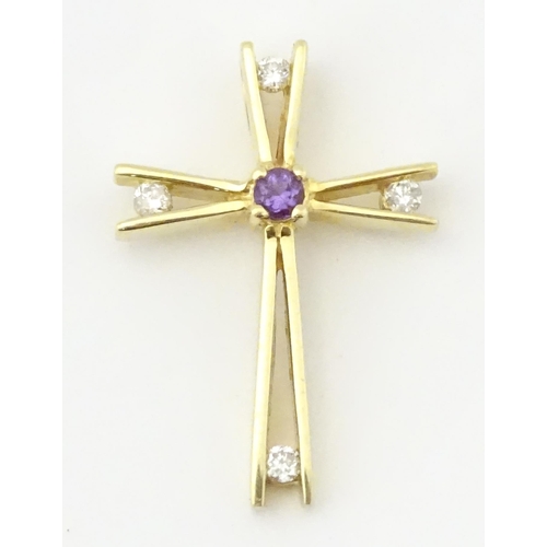 749 - A 14ct gold pendant of cross form set with amethysts and diamonds. Approx. 1