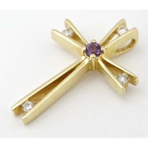 749 - A 14ct gold pendant of cross form set with amethysts and diamonds. Approx. 1