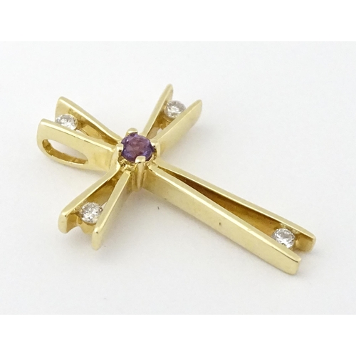 749 - A 14ct gold pendant of cross form set with amethysts and diamonds. Approx. 1