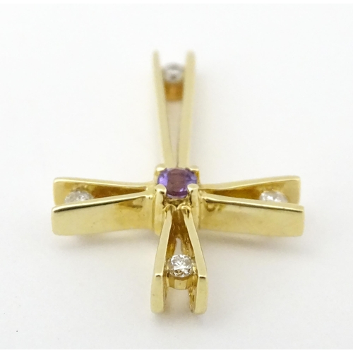 749 - A 14ct gold pendant of cross form set with amethysts and diamonds. Approx. 1