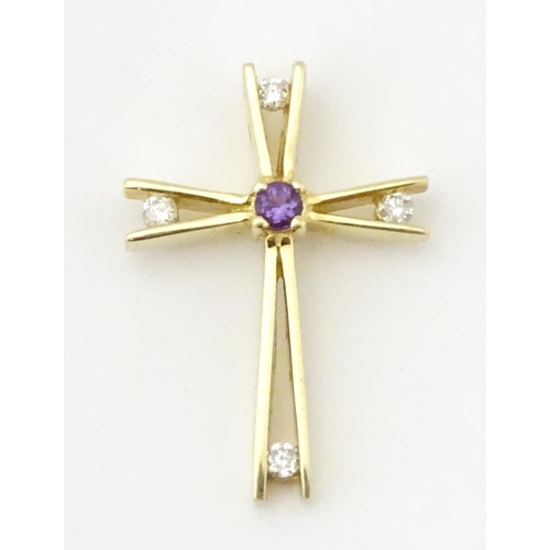 749 - A 14ct gold pendant of cross form set with amethysts and diamonds. Approx. 1